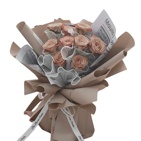 pink campagne roses wrapped in champagne bouquet 