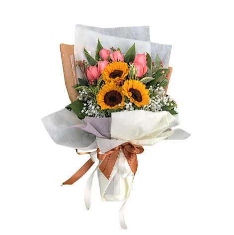 three sunflowers and some pink roses wrapped in white paper with brown ribbon flower bouquet 