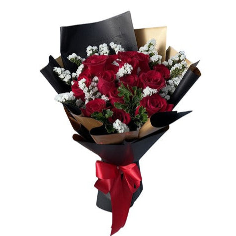 Bouquet of red roses with a black wrap and red ribbon on a white background